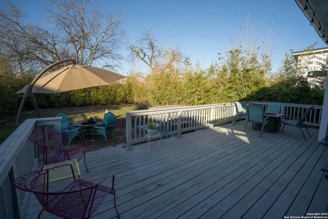 a view of a roof deck with table and chairs and wooden floor