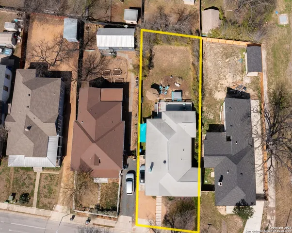 an aerial view of residential houses with outdoor space