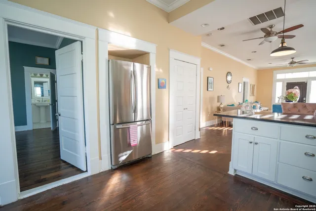 a kitchen with stainless steel appliances a refrigerator and wooden cabinets