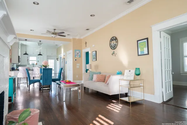 a living room with furniture and wooden floor