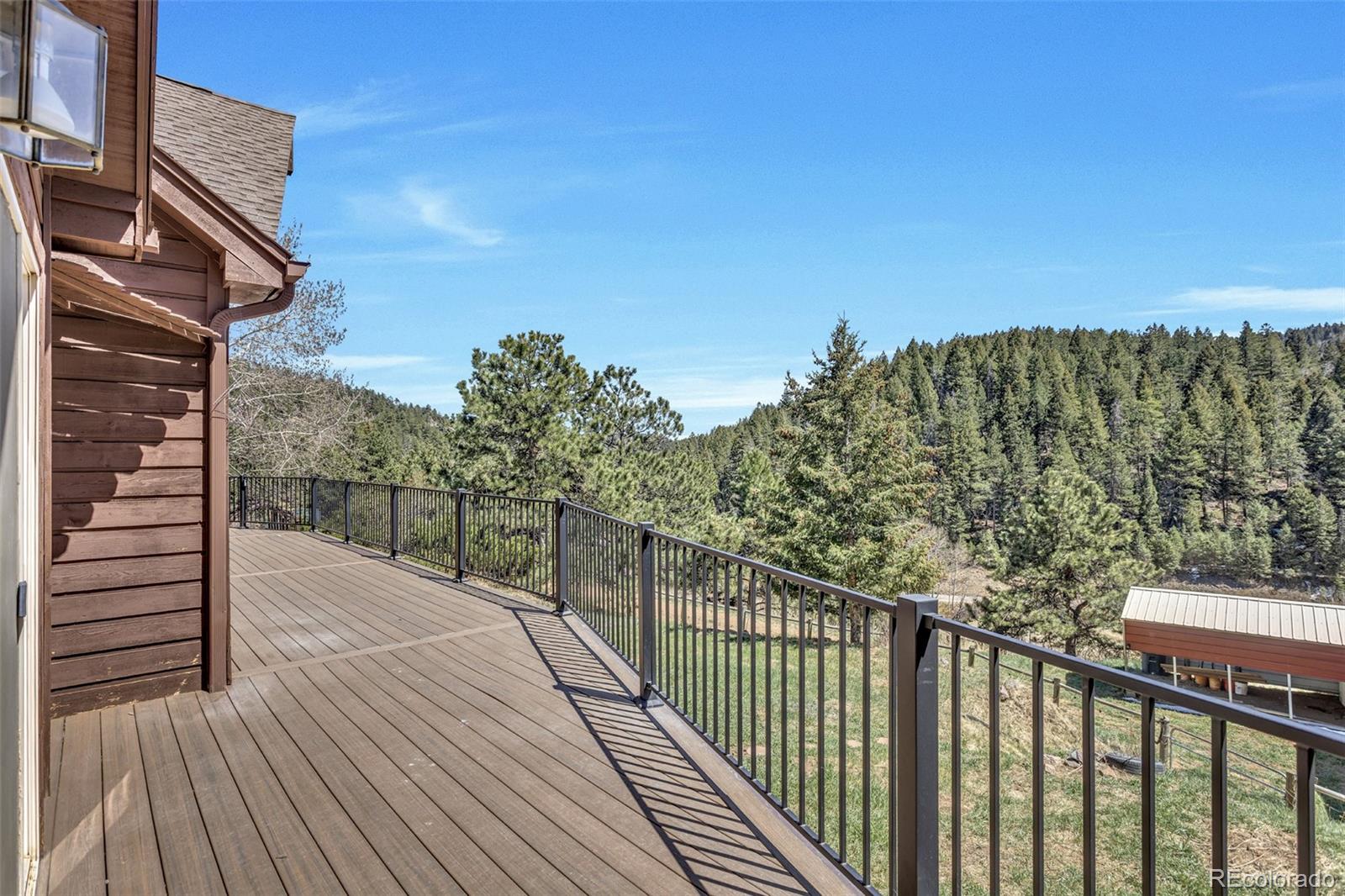 12183 Arnett Ranch Road Littleton, CO 80127 - Photo 23 of 28 a view of a balcony with wooden floor and city view