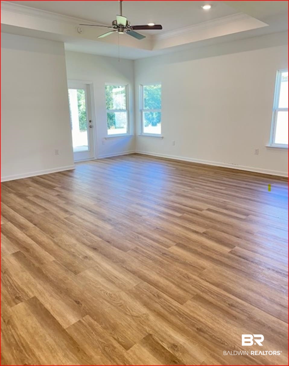 13906 Antler Hl Road Daphne, AL 36527 - Photo 5 of 23 Spare room featuring ceiling fan, crown molding, a tray ceiling, and light hardwood / wood-style flooring
