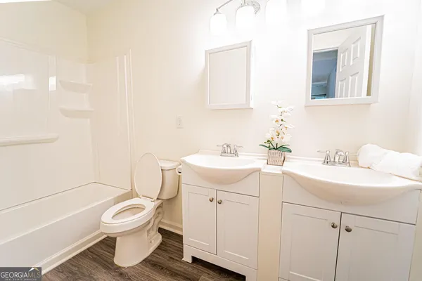 a bathroom with a sink toilet and vanity