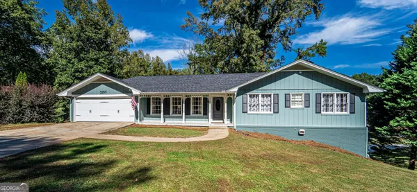 a front view of a house with a yard and garage