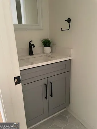 a bathroom with a sink and mirror