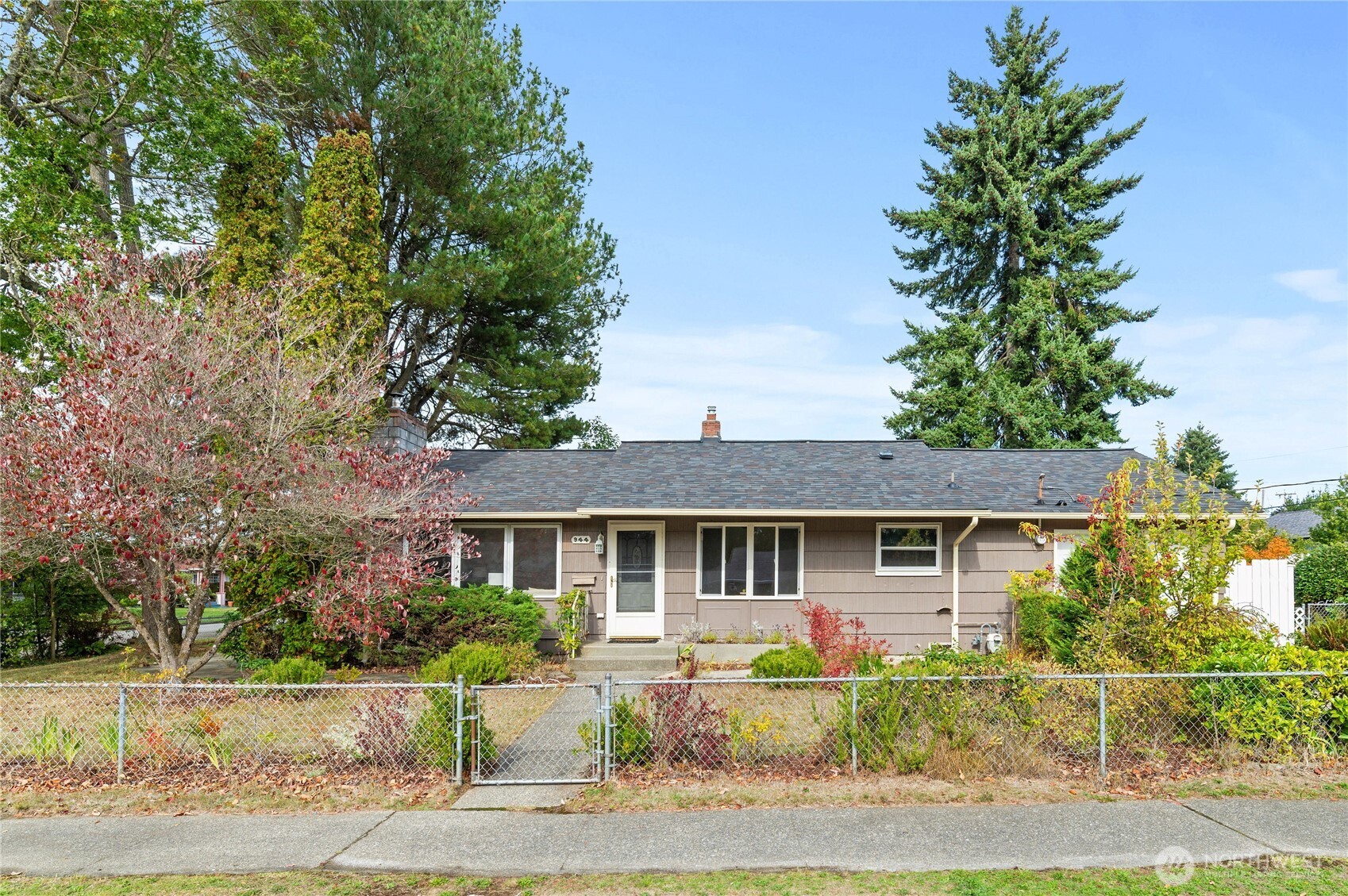 a front view of a house with a yard and potted plants