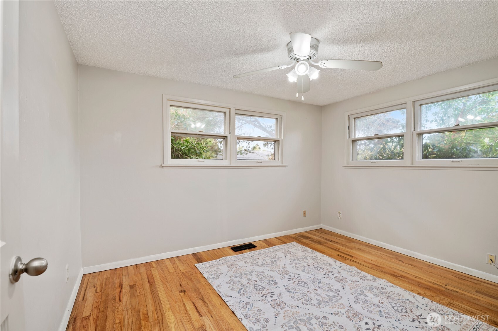 944 East 30th Street Bremerton, WA 98310 - Photo 14 of 21 a view of a room with wooden floor and chandelier fan