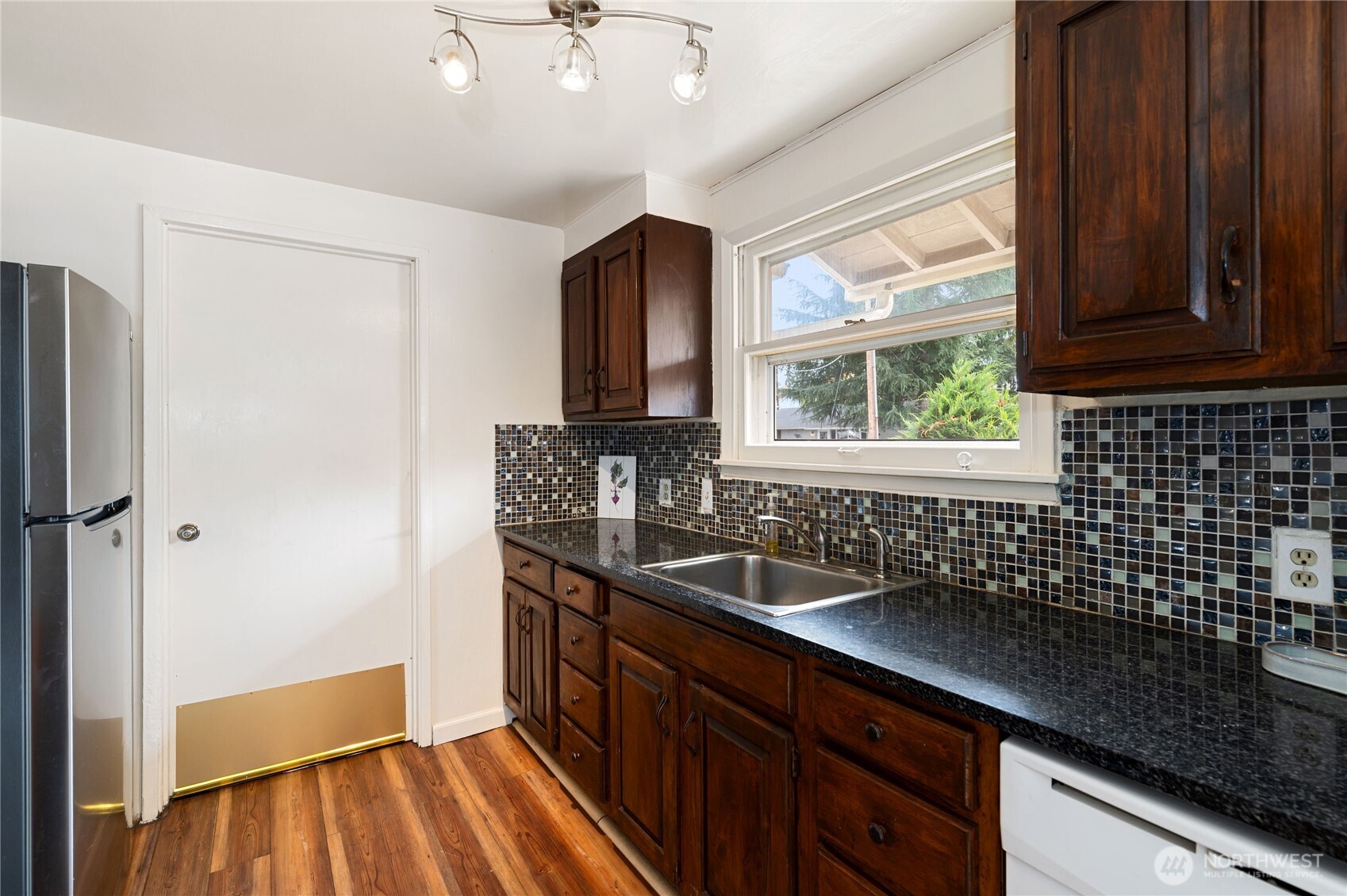 944 East 30th Street Bremerton, WA 98310 - Photo 8 of 21 a kitchen with a sink and wooden cabinets
