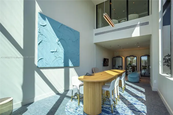 a view of a patio with couches table and chairs with wooden floor and fence