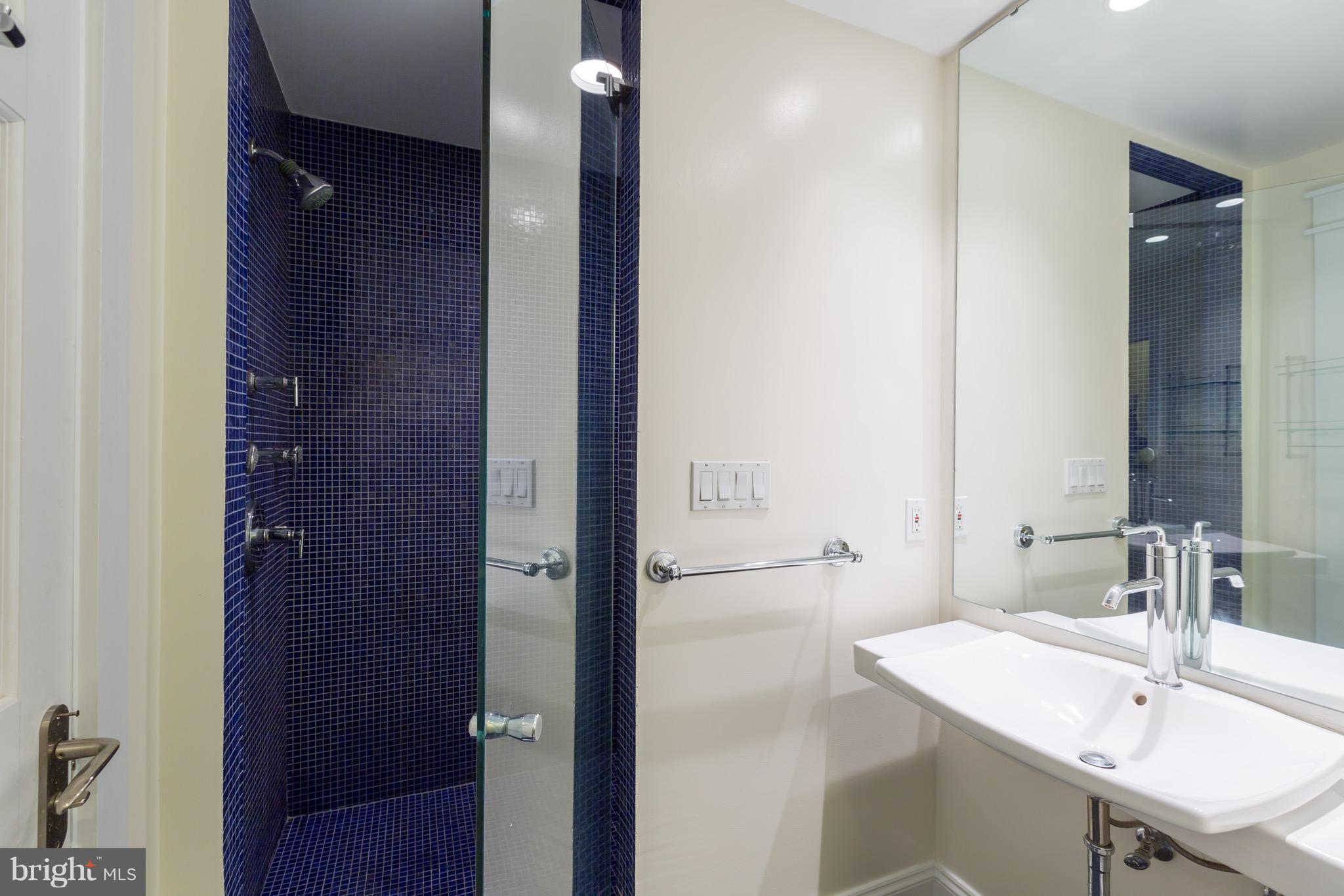 4926 43rd Place Northwest Washington, DC 20016 - Photo 15 of 23 a bathroom with a sink and a mirror