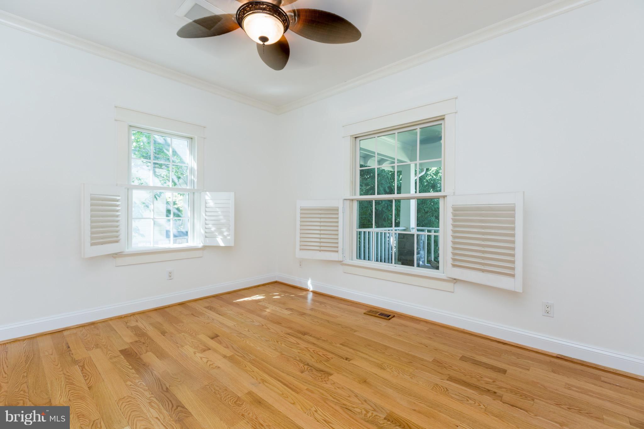 4926 43rd Place Northwest Washington, DC 20016 - Photo 9 of 23 a view of an empty room with a window and wooden floor