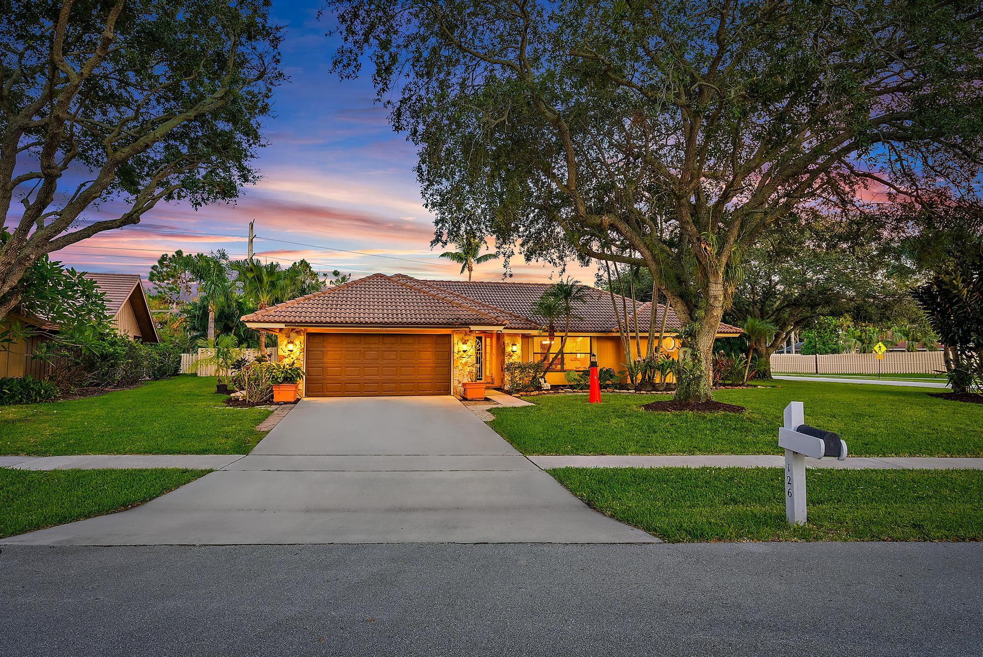 126 Coco Lane Jupiter, FL 33458 - Photo 22 of 40 a front view of house with yard and green space