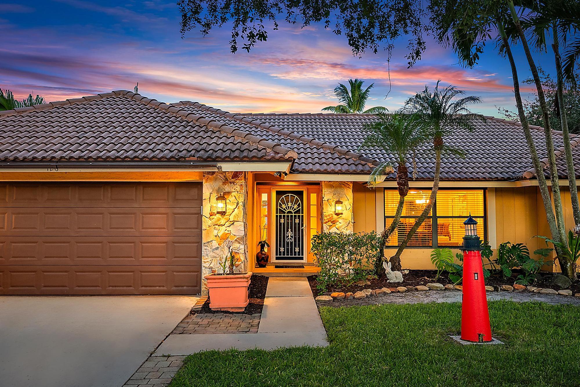 126 Coco Lane Jupiter, FL 33458 - Photo 23 of 40 a front view of a house with garden