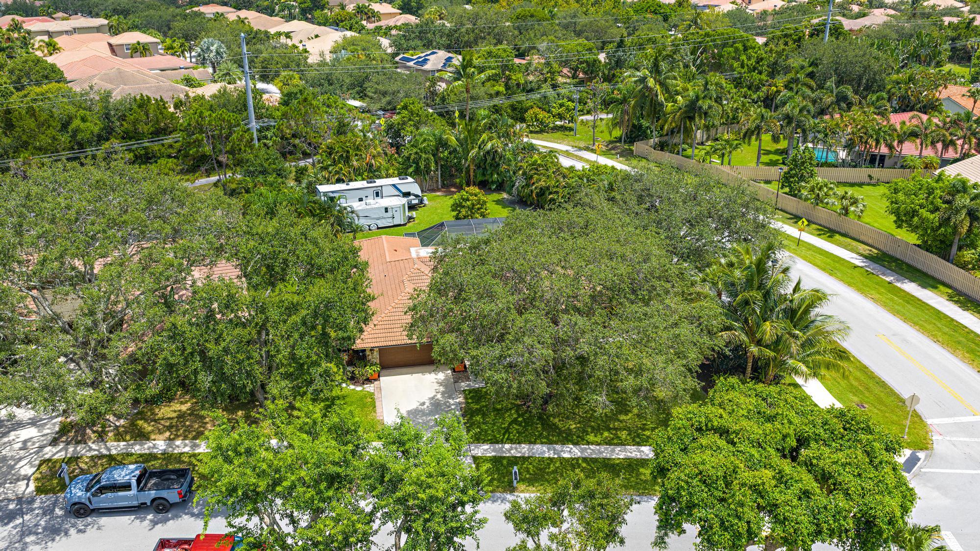 126 Coco Lane Jupiter, FL 33458 - Photo 36 of 40 an aerial view of residential house with outdoor space and trees all around