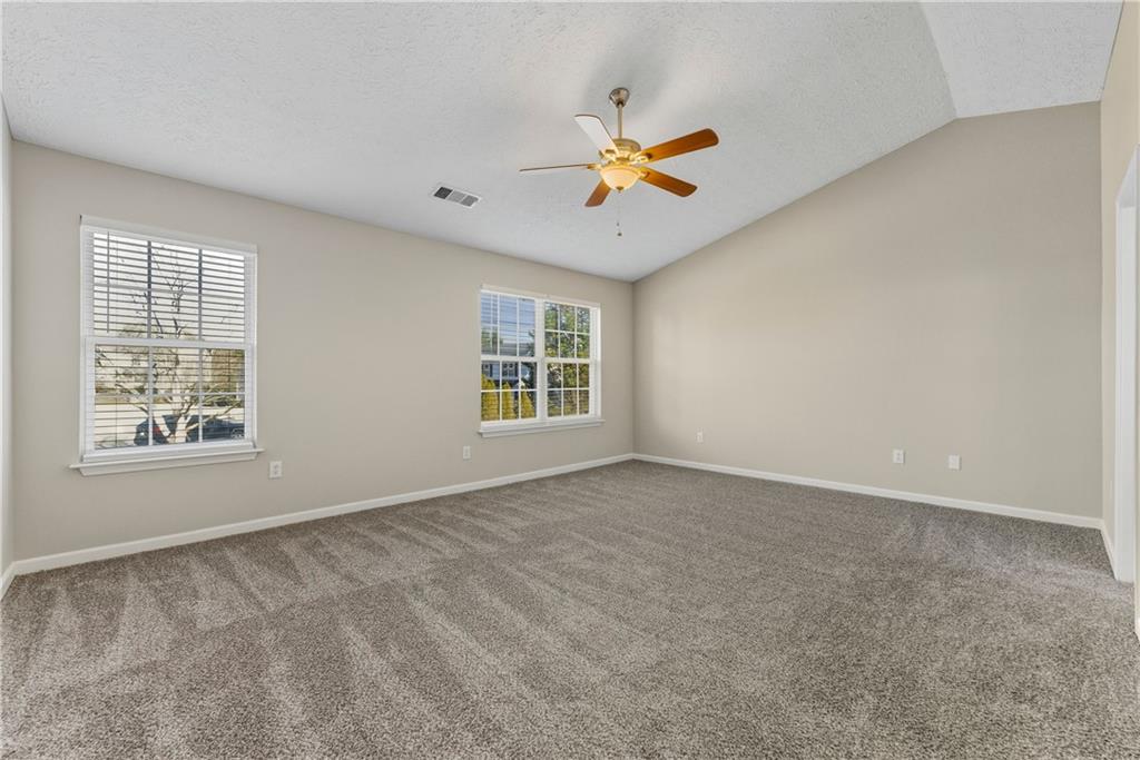 7570 Old Field Cove Road Cumming, GA 30028 - Photo 14 of 18 an empty room with windows