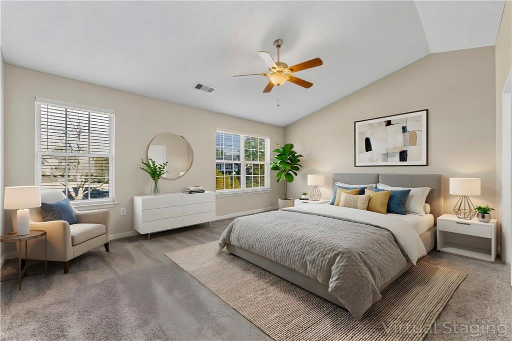 7570 Old Field Cove Road Cumming, GA 30028 - Photo 15 of 18 a bedroom with a large bed and a couch