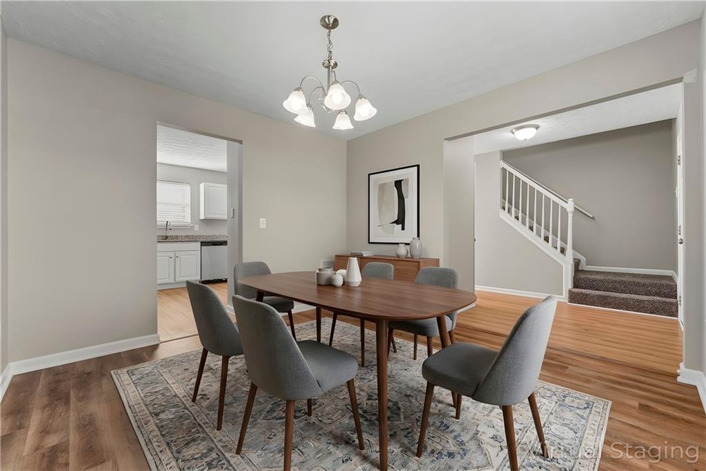 7570 Old Field Cove Road Cumming, GA 30028 - Photo 4 of 18 a view of a dining room with furniture and wooden floor