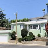 a view of a house with a yard and plants