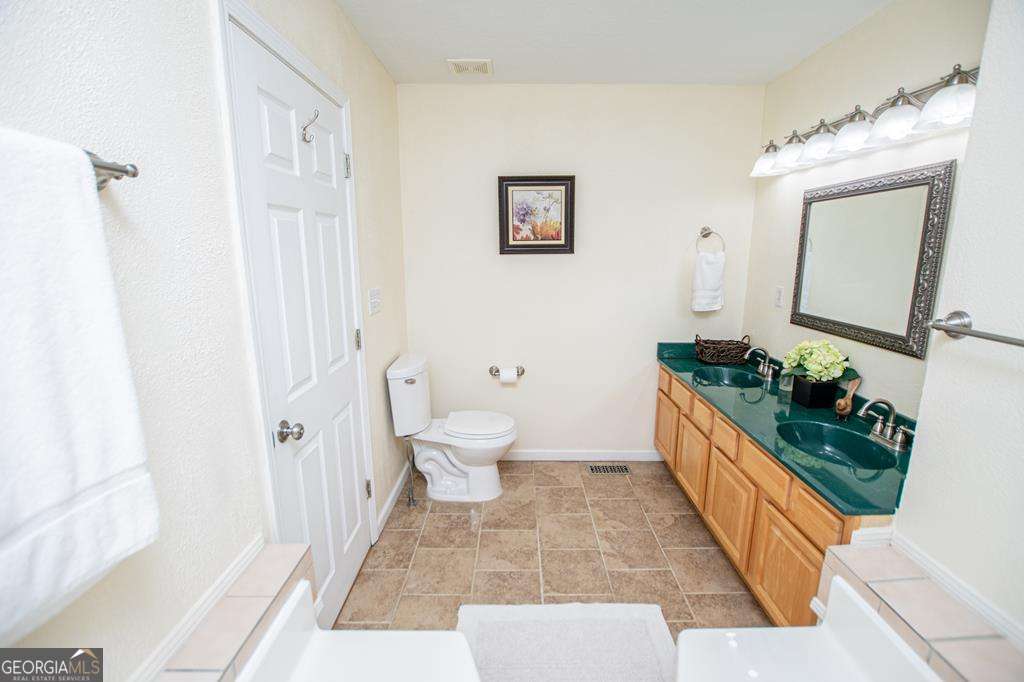 2 Pine Hill Drive Ranburne, AL 36273 - Photo 45 of 91 a bathroom with a toilet sink and mirror