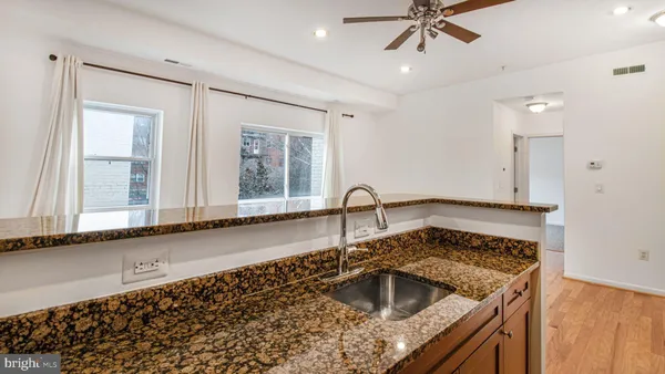 a kitchen with a sink stove top oven and microwave