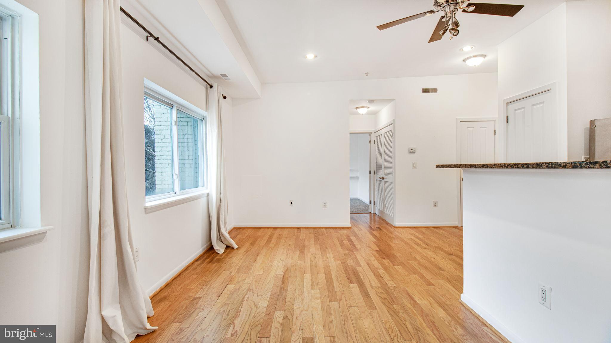 1501 27th Street Southeast, Unit 406 Washington, DC 20020 - Photo 16 of 44 a view of a room with wooden floor and a ceiling fan