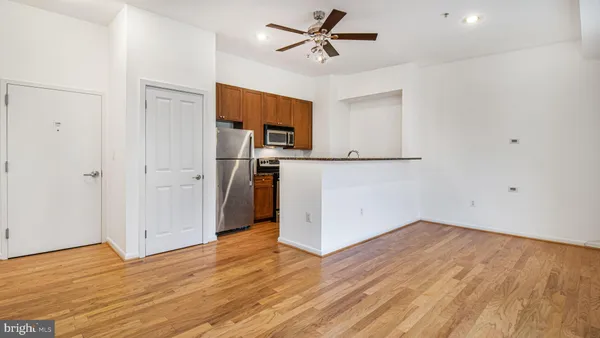 a view of a kitchen with a sink and a refrigerator
