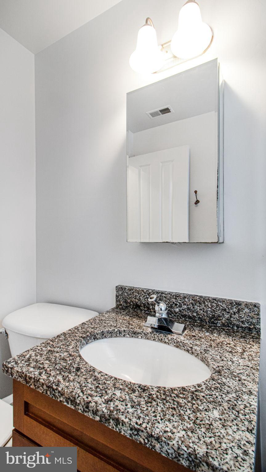 1501 27th Street Southeast, Unit 406 Washington, DC 20020 - Photo 27 of 44 a bathroom with a bathtub and mirror
