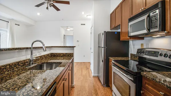 a kitchen with a stove microwave and sink