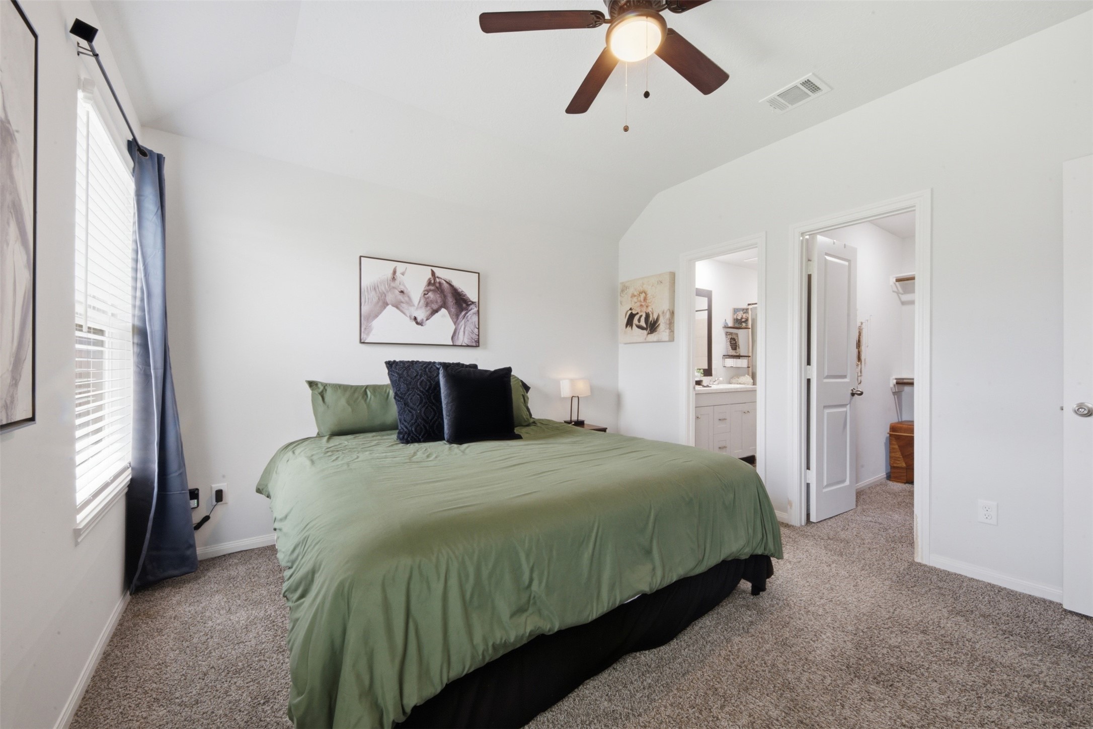 1523 22nd Street Hempstead, TX 77445 - Photo 13 of 26 Large primary suite with neutral colors and abundant natural light featuring an ensuite bath and walk in closet.