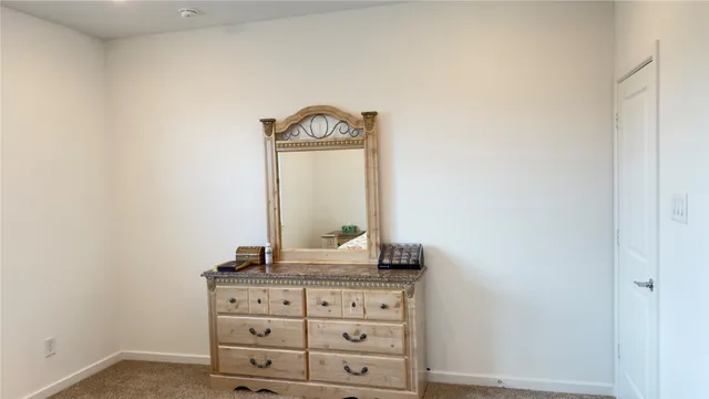 a close view of dresser with mirror
