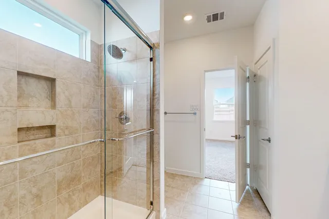 a bathroom with a glass shower door