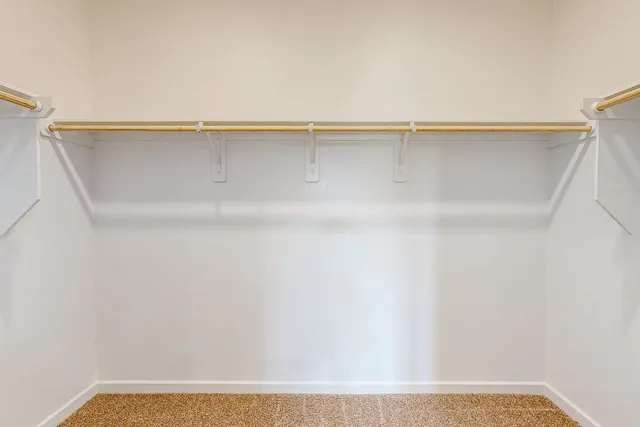 a view of a closet with wooden floor