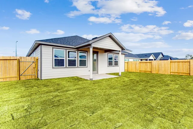 a view of a house with a backyard