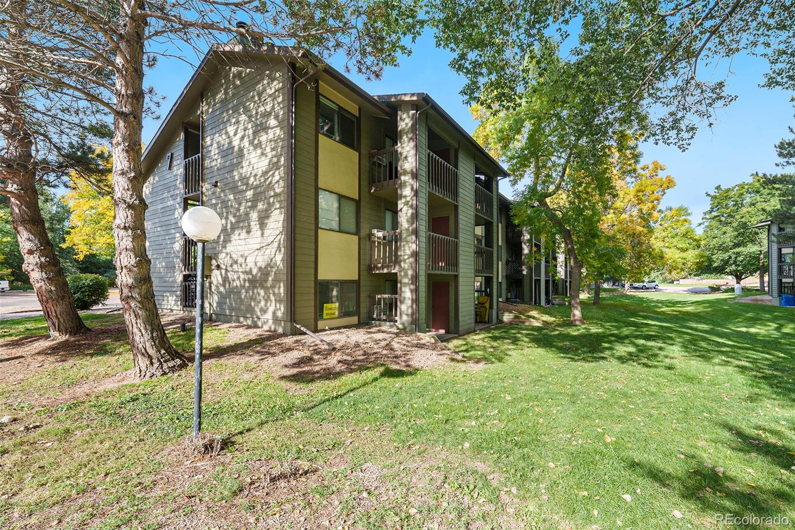 925 Columbia Road, Unit 726 Fort Collins, CO 80525 - Photo 13 of 14 a view of a house with a yard