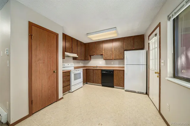a kitchen with stainless steel appliances a refrigerator sink and cabinets