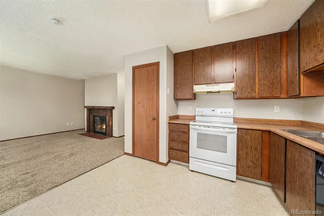 a kitchen with cabinets and white appliances