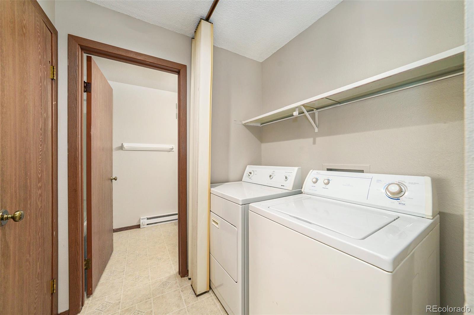 925 Columbia Road, Unit 726 Fort Collins, CO 80525 - Photo 10 of 14 a view of storage and utility room with washer and dryer