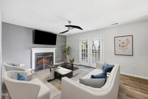 a view of a livingroom with a fireplace wooden floor and cabinet