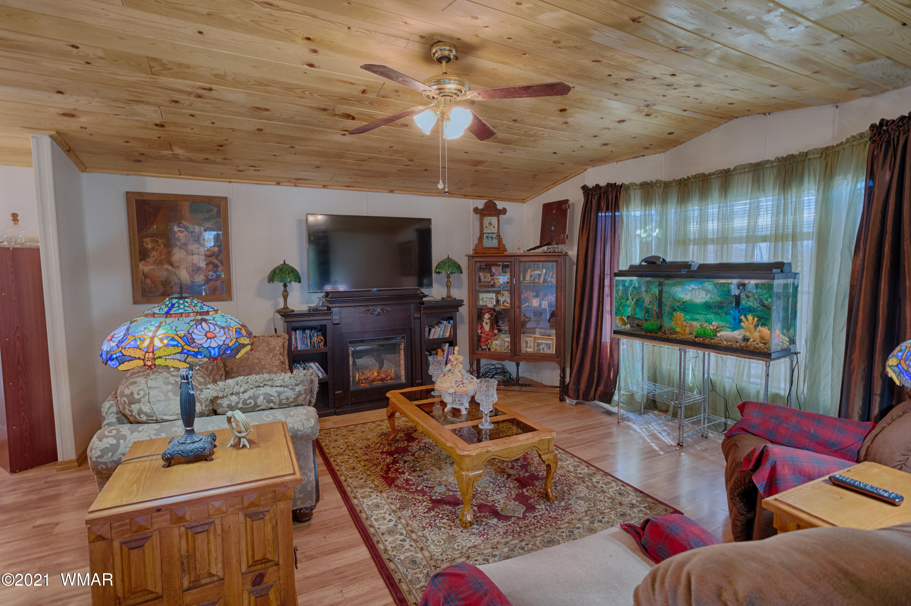 3359 Rim Lakes Drive Overgaard, AZ 85933 - Photo 3 of 17 a living room with furniture a flat screen tv and a dining table