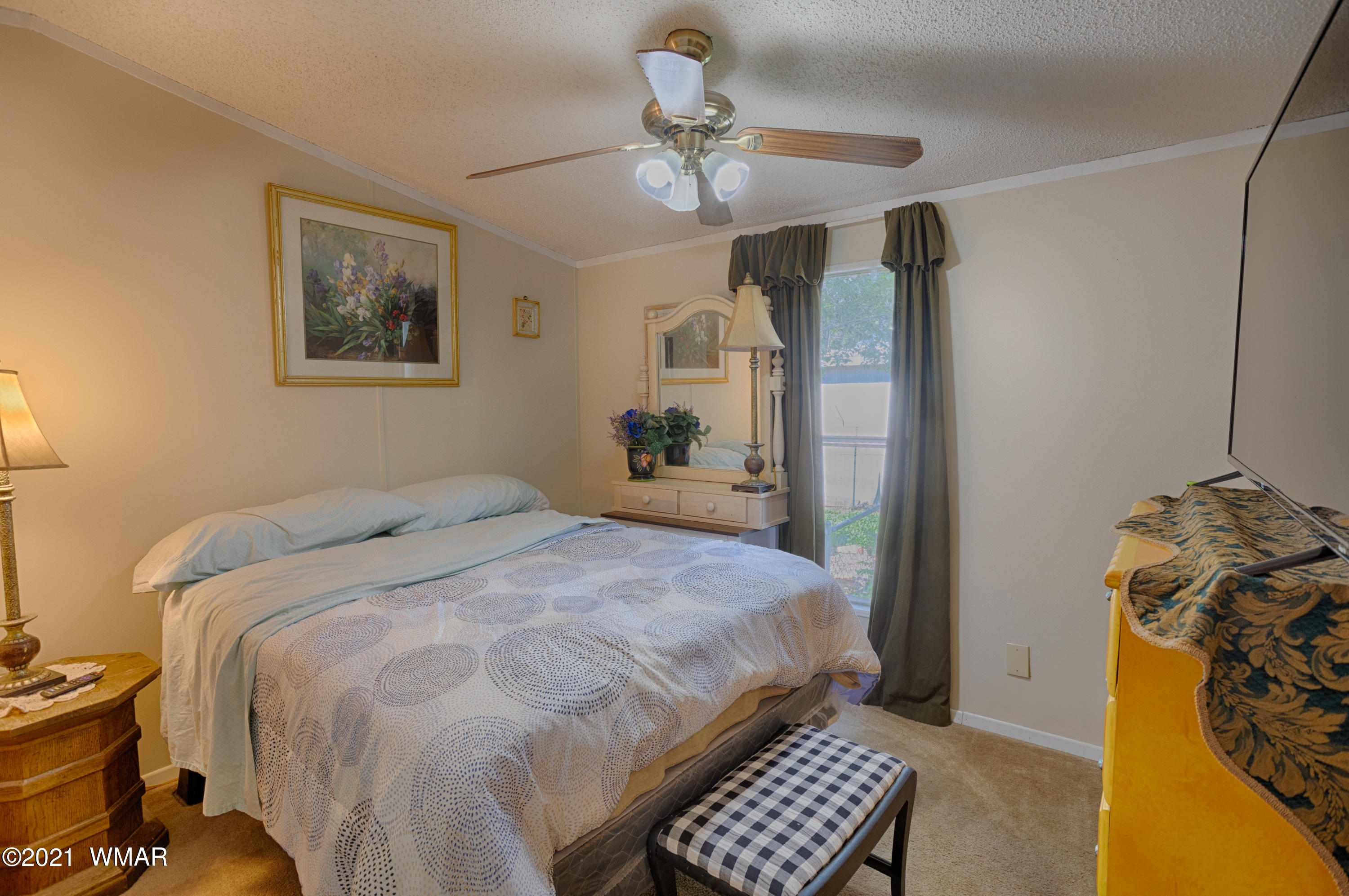 3359 Rim Lakes Drive Overgaard, AZ 85933 - Photo 8 of 17 a bedroom with a bed and a chandelier