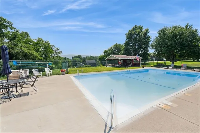 a view of a swimming pool with a patio