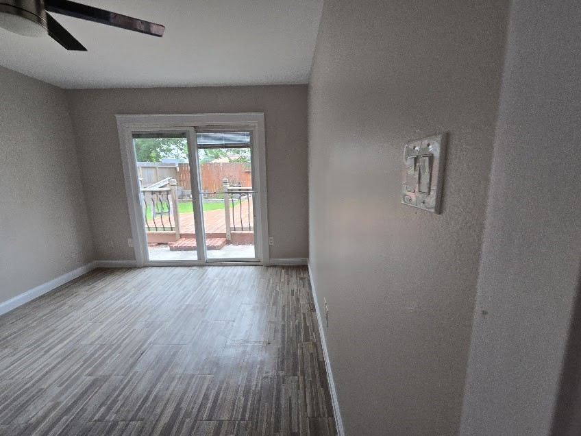1110 Greencroft Street Channelview, TX 77530 - Photo 9 of 24 an empty room with wooden floor and windows