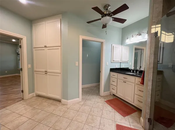 a large white kitchen with white cabinets and stainless steel appliances