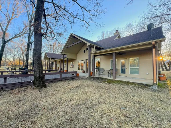 a view of a house with a yard and sitting area