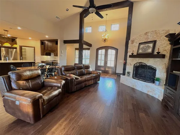 a living room with fireplace furniture and a wooden floor