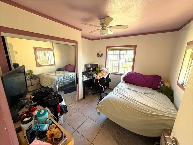 a bedroom with bed and a window