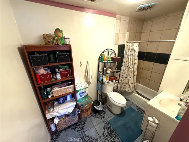 a living room with furniture and a toilet