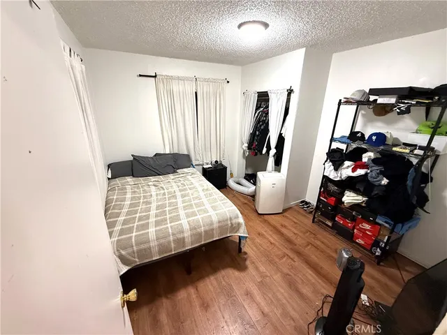 a bedroom with bed and a large mirror