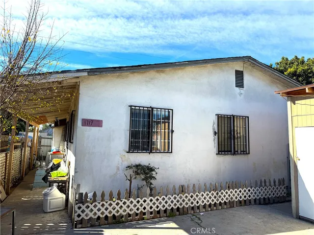 a front view of a house with glass top table and chairs