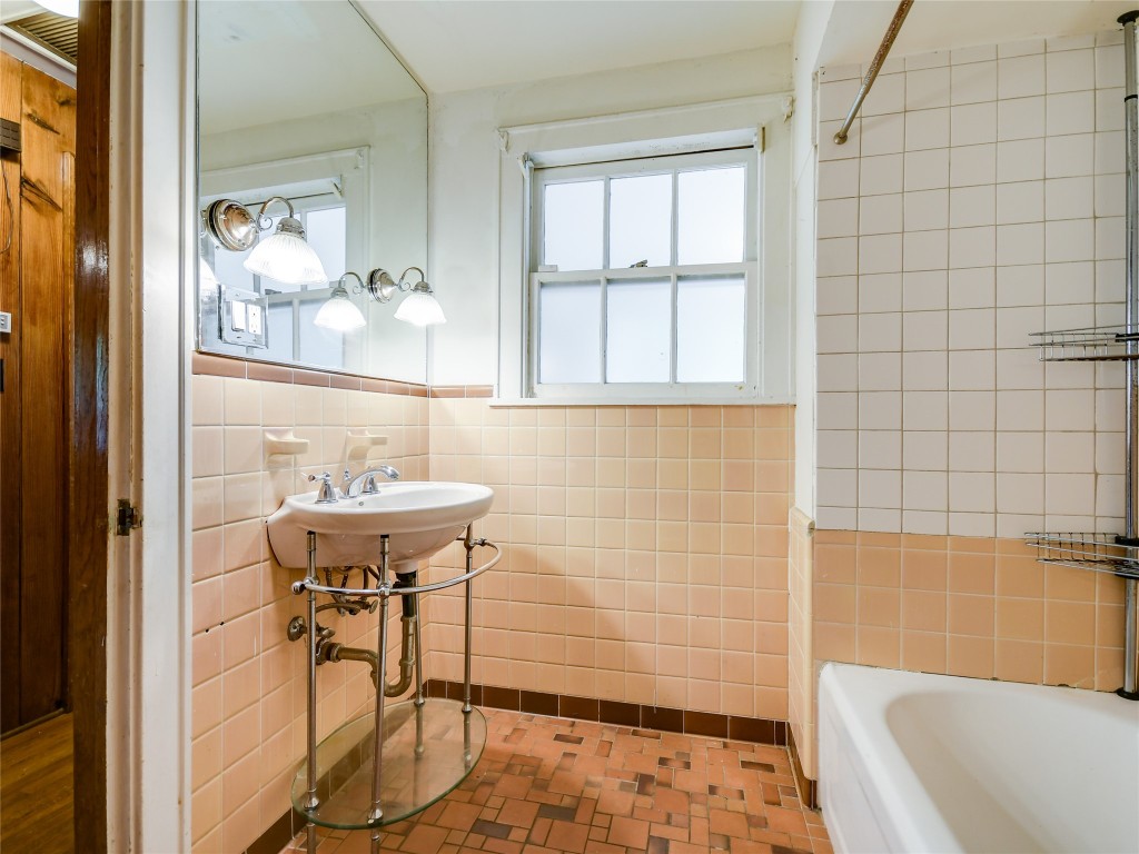 2304 Longview Street Austin, TX 78705 - Photo 17 of 31 a bathroom with a sink and a bathtub